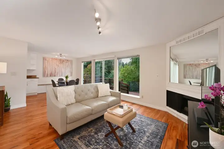 The living room has a place for a dining room table and there is a built-in seating area with storage below.