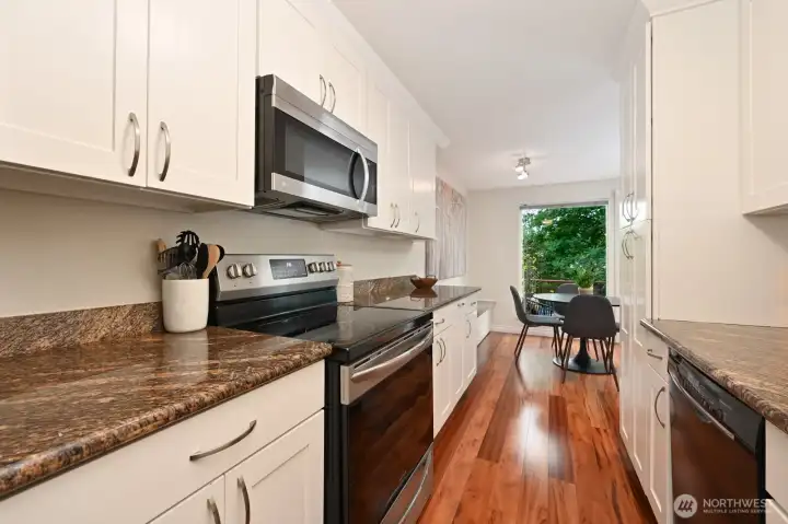 Plenty of cabinets and granite countertops.