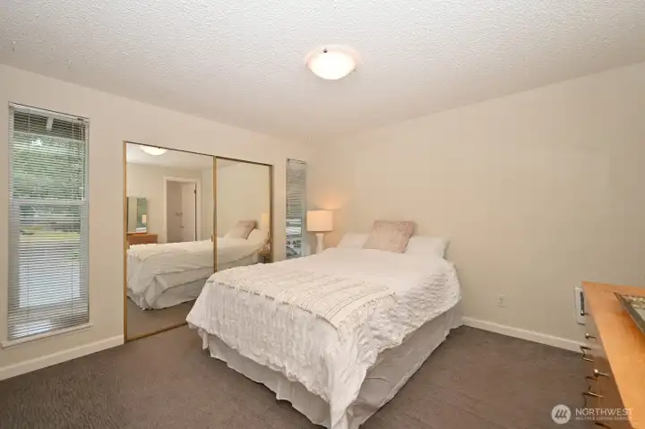 Primary bedroom with a large closet and a half bath.