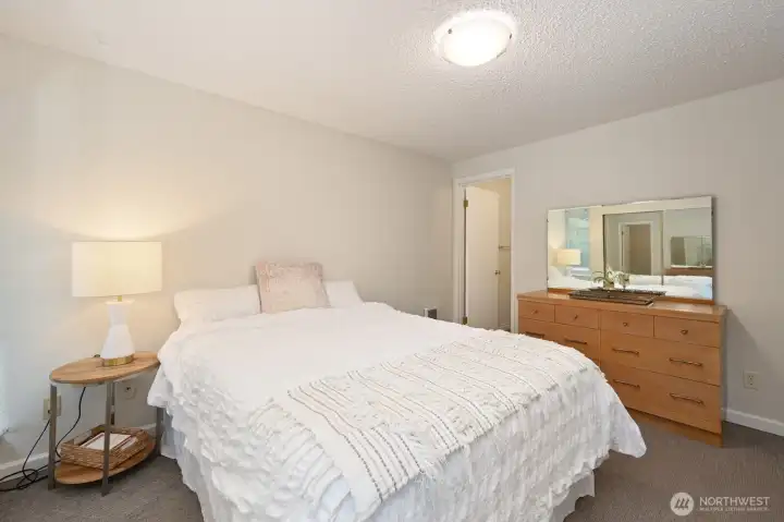 Primary bedroom with door to the half bath.