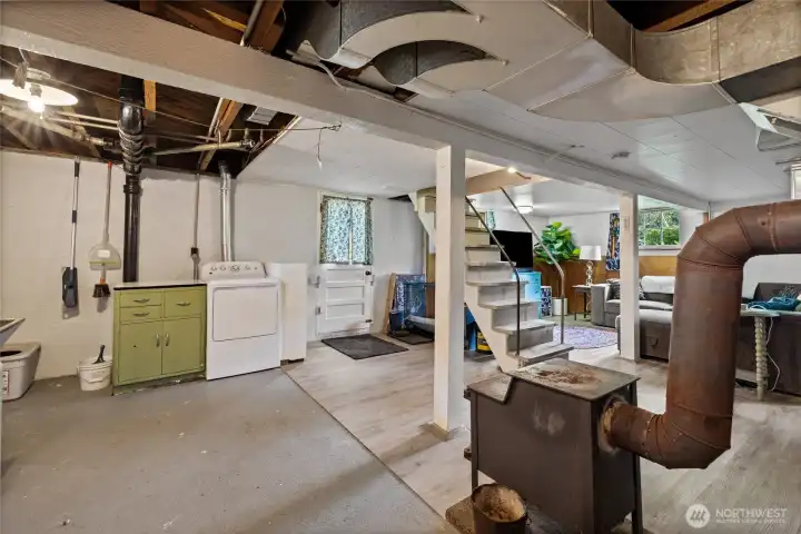 Basement also features Utility Area, wood stove and door to back yard