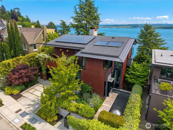 World class design and build quality. Cor10 steel siding, steel and glass construction, floating entry walkway, mature landscaping + privacy.  Solar panels for hot water, Standing seam metal roof,