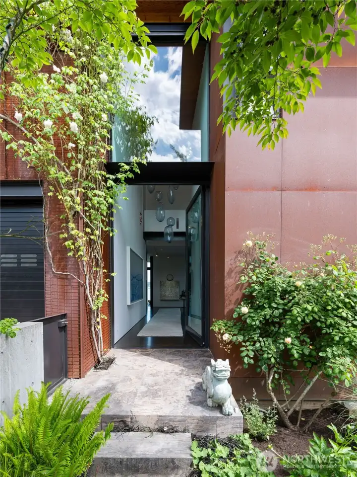 Center hallway with a 20' glass door and fixed lite creates a dramatic space for art.