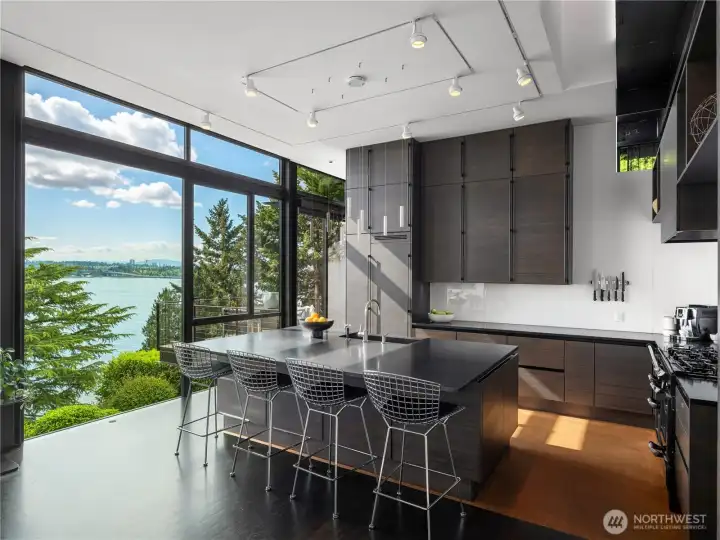 Panoramic views from the kitchen. Details include: Cork flooring, AGA gas range, custom cabinetry and storage solutions, breakfast bar and honed stone counters.