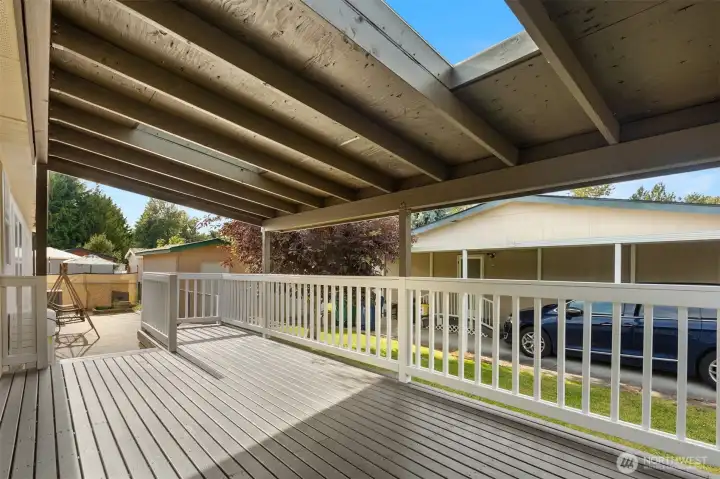 Expansive Covered Deck Provides a Private Outdoor Retreat with Ample Space for Seating, Grilling, and Gathering with Friends and Family