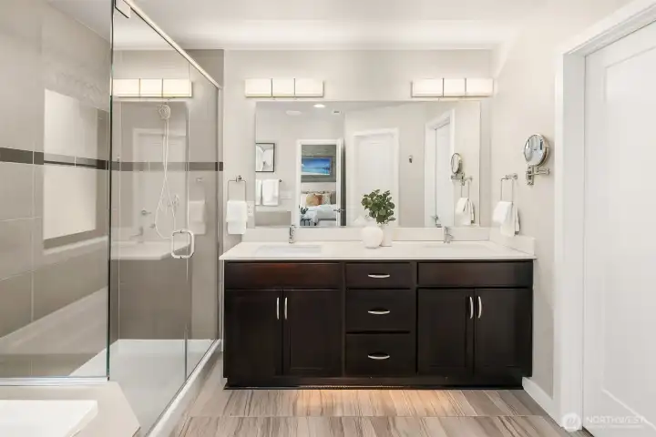 Primary bath with dual vanities, walk-in shower and soaking tub