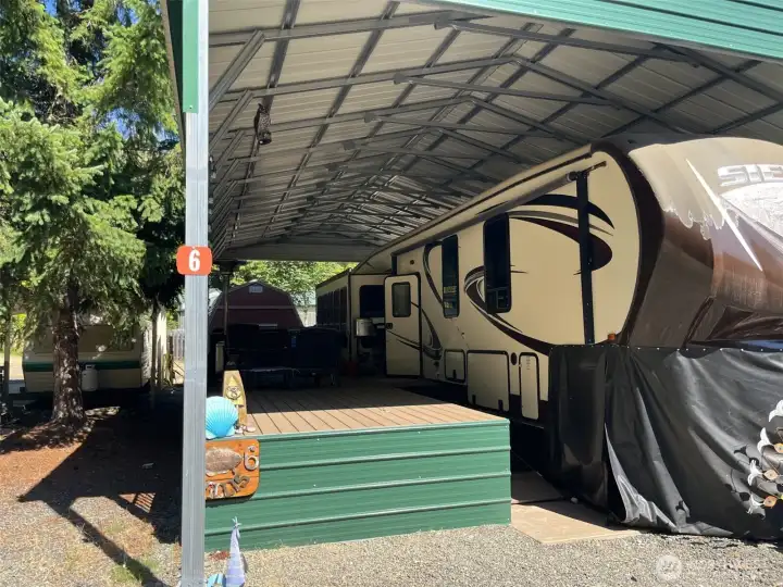 Ramp has been installed for convenient access. Covered "trex" deck and storage shed. Adjacent trailer to the left on lot #7. Ramp has been installed for convenient access. Covered "trex" deck and storage shed. Adjacent trailer to the left on lot #7.