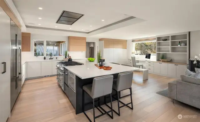 Amazing cabinetry adorn this epicurean's kitchen. check out the custom built in desk space in the background.