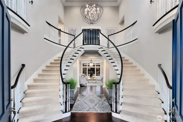 A Dramatic Entrance To A Stunningly Beautiful Home. Two-Story Foyer Features A Double Staircase, Juliet Balconies, Custom Lighting And Gleaming Hardwood Floors.