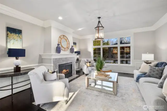Exquisite Living Room Featuring Gas Fireplace & Crown Molding Adding A Touch Of Sophistacation And Timeless Elegance.