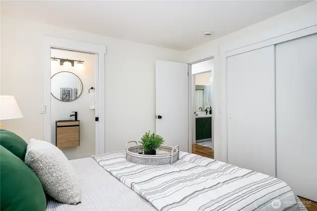 Primary bedroom with en-suite ¾ bath, shown here looking toward the hallway. The guest bathroom is just across the hall to the right.