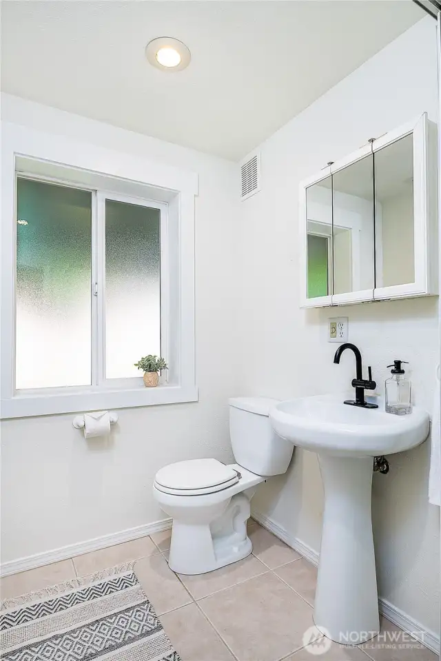 Downstairs 3/4 bath feels clean and spacious.