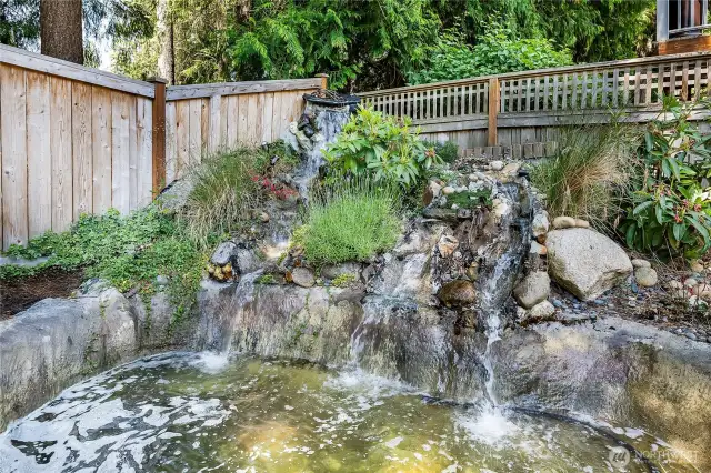 Serene backyard pond with a WiFi-enabled waterfall—adjust the sound and flow to suit your mood. A peaceful retreat for your backyard escape.