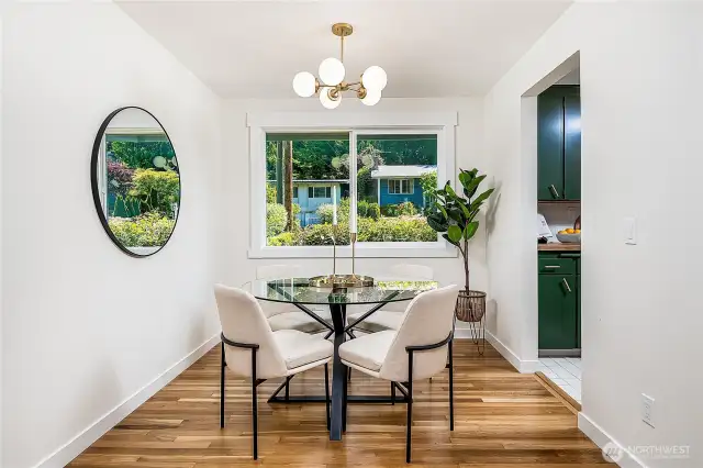 Enjoy morning light through the east-facing front window. The living room flows into the dining area and connects easily to the kitchen on the right.