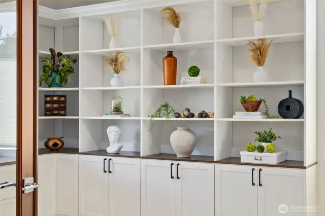 Main floor office with designer built in shelving for multipurpose usage.