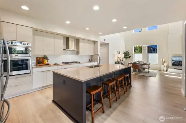 Oversized Island in your chefs dream kitchen with quartz counters and luxury appliances.