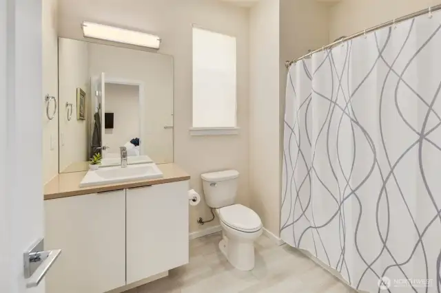 Full separate bath in main floor primary suite.