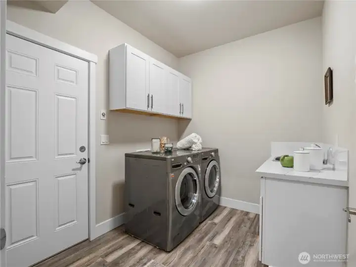 The laundry toom is conveniently located at the entrance to the garage.