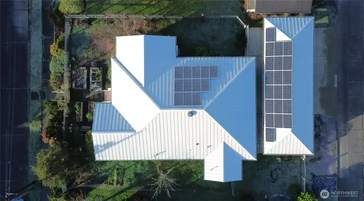 Home, carport & attached storage from above with solar panels