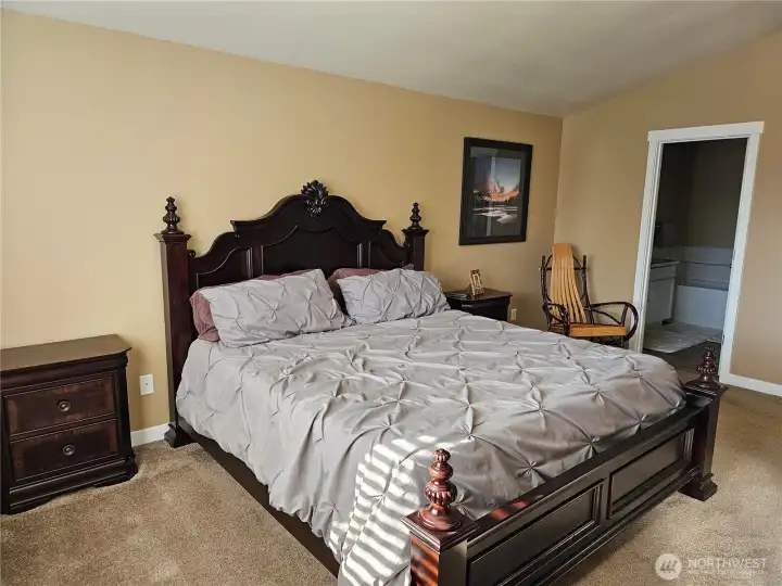 Primary bedroom with vaulted ceilings