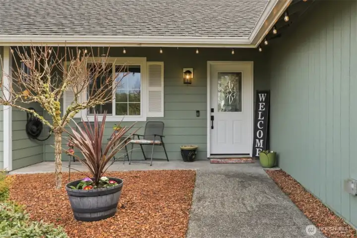 Lovely beveled glass front door also allows light in to the entry; window trim and shutters are another quality detail.