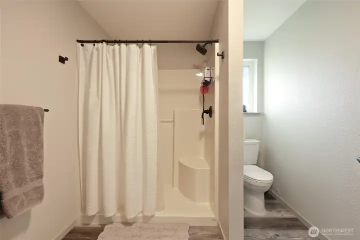 Separate room for shower/commode are ideal for privacy and warmth; another frosted window here, too.