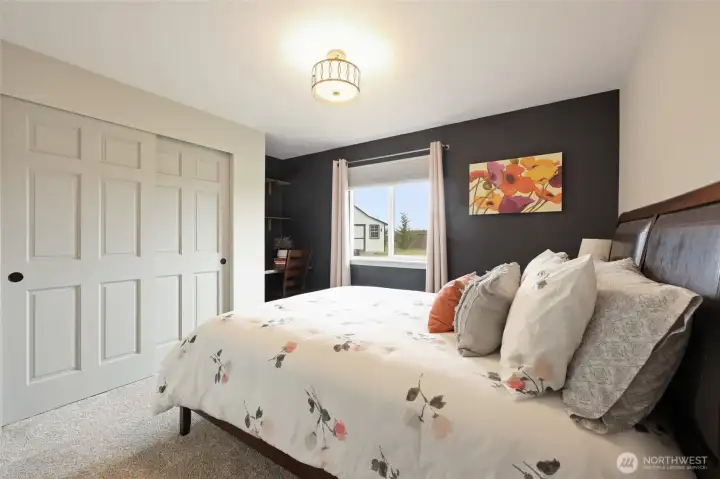 Bedroom #3 has a backyard view; built-in desk and stylish light fixture are added details.
