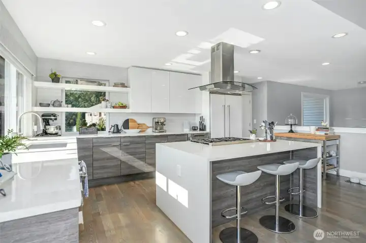 Chef’s kitchen comes complete with a new Thermador range, dishwasher, waterfall island, and custom walk-in pantry