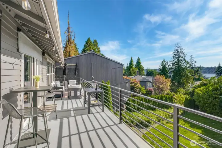 Multiple outdoor entertaining spaces with deck and wraparound patio