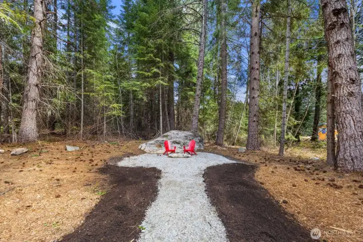 Fire pit set on a spacious 1.2-acre property, perfect for gathering under the stars.