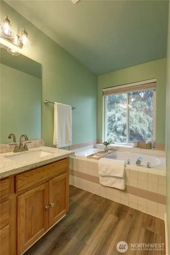 The soaking tub in the primary bath invites relaxation.