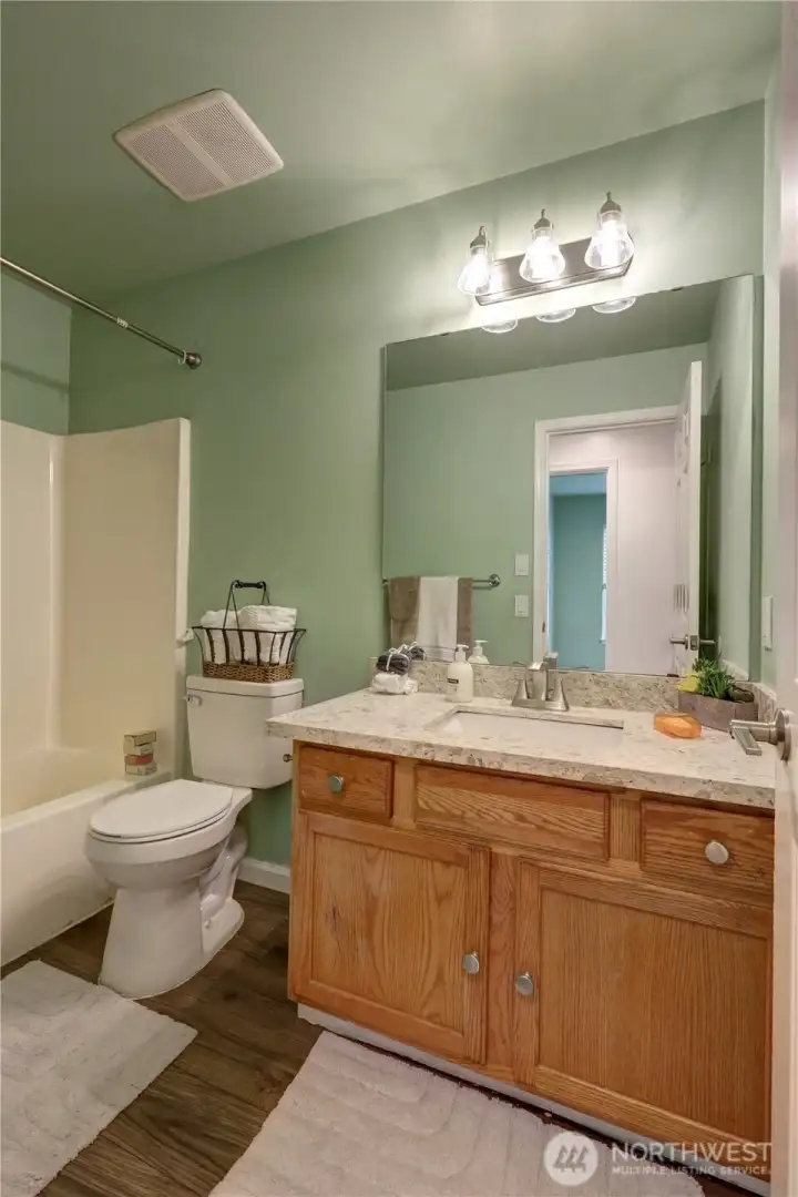 Full bath with tub/shower combo.
