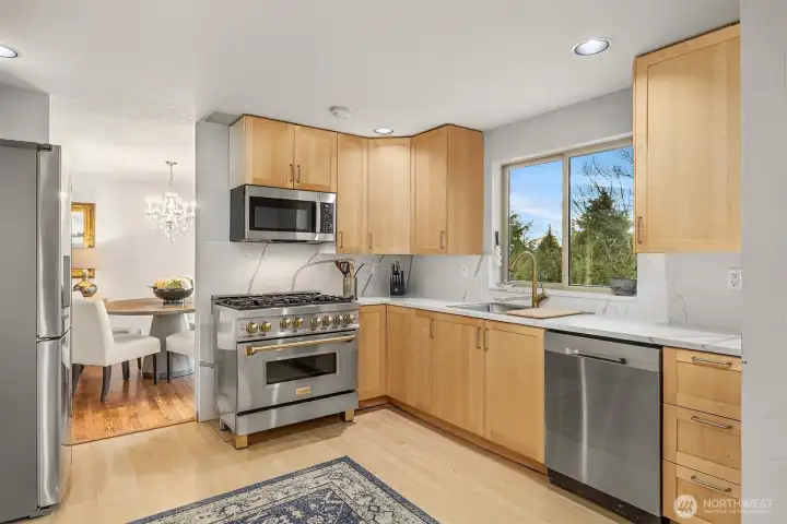 The chef's kitchen boasts this lovely gas range with brushed gold hardware. The chef's kitchen boasts this lovely gas range with brushed gold hardware.
