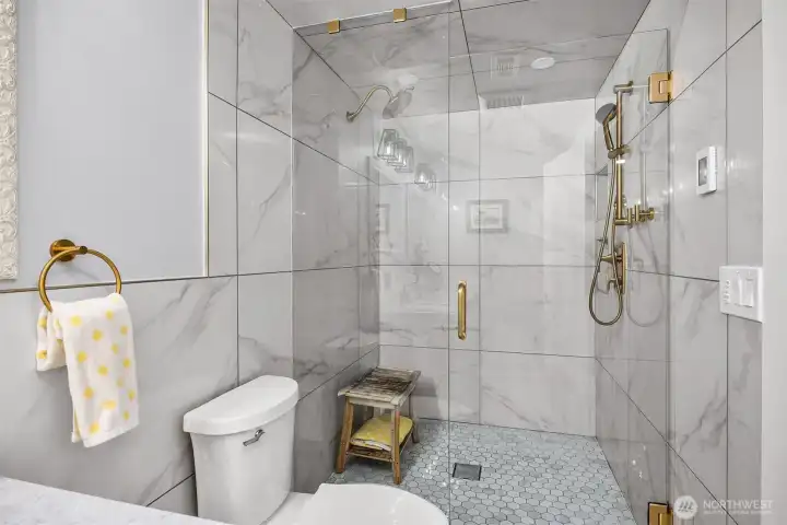 The beautiful double shower with seamless glass door. and brushed gold hardware. The beautiful double shower with seamless glass door. and brushed gold hardware.