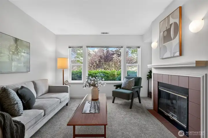 Light-filled living room with fireplace and fairway views