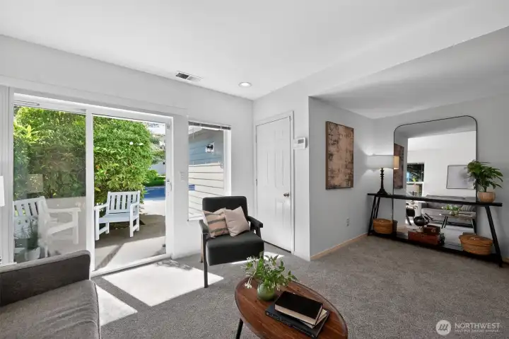 Bright sitting area overlooking mature landscaping