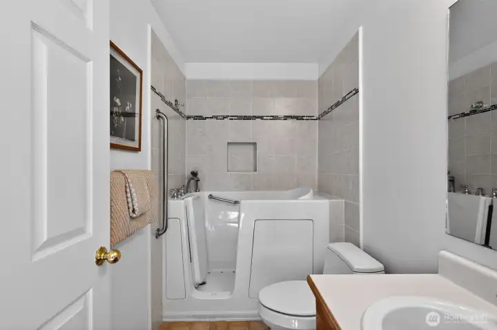 Accessible full bath featuring a jetted soaking tub