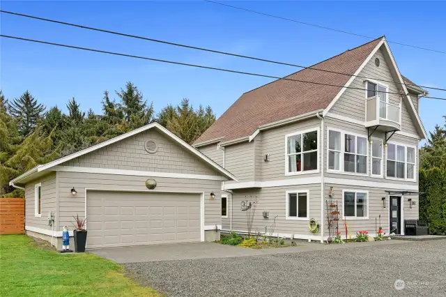 The front of the home with detached two car garage & shop space