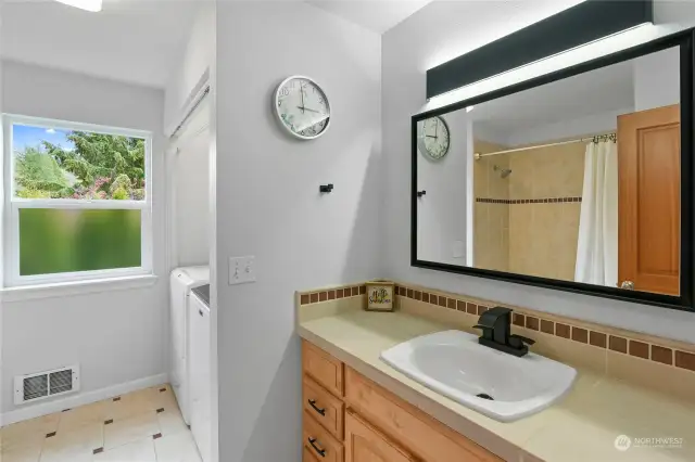 One of three baths, this one contains the laundry area.