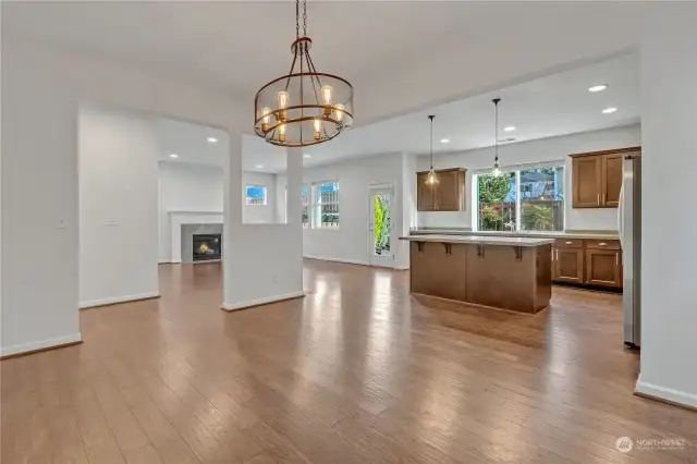 Standing in the dining room, looking into the kitchen and living room