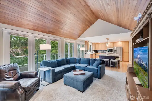 Family room off the kitchen with wood accented vaulted ceilings