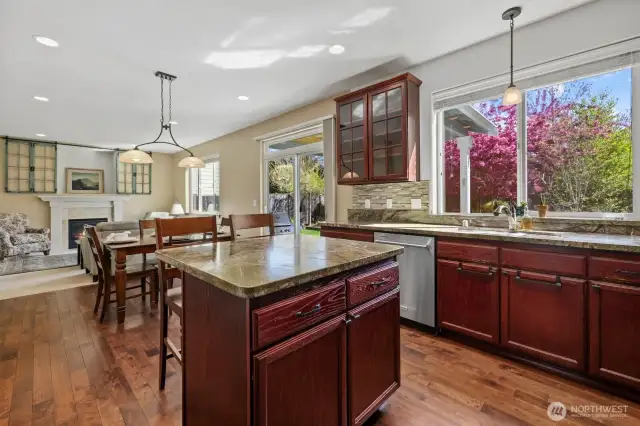 View of open concept kitchen/dining/family room, backyard sliding door just off of dining room
