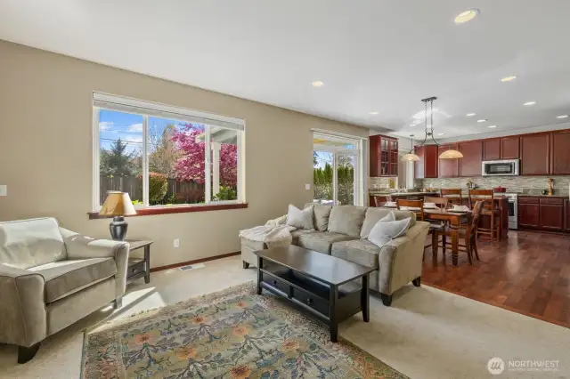 View of open concept kitchen/dining/family room, backyard sliding door just off of dining room