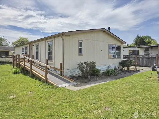 Welcome to this small (only 18 homes) 55+ park. This is the end unit with a nice back yard area and ramp for easy access.