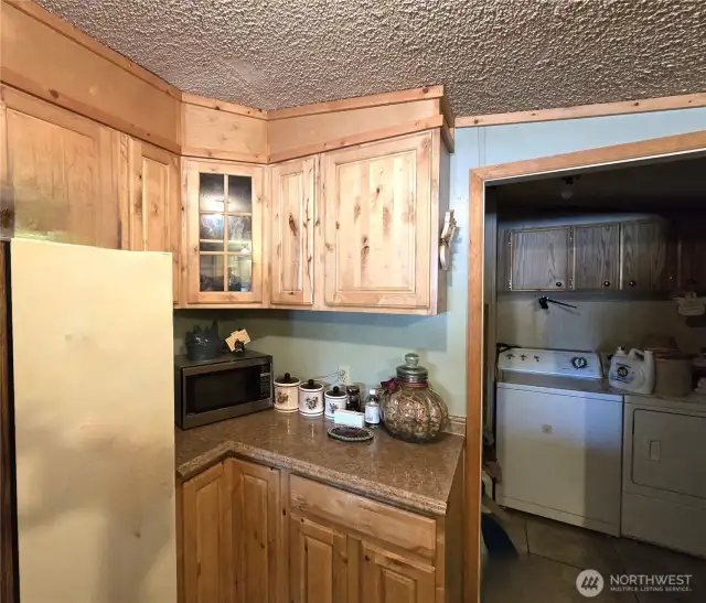 The kitchen cabinets are beautiful pine cabinets with updated countertops- This photo had personal items digitally removed from the refrigerator.  The laundry room has the cabinets that were repurposed from the kitchen