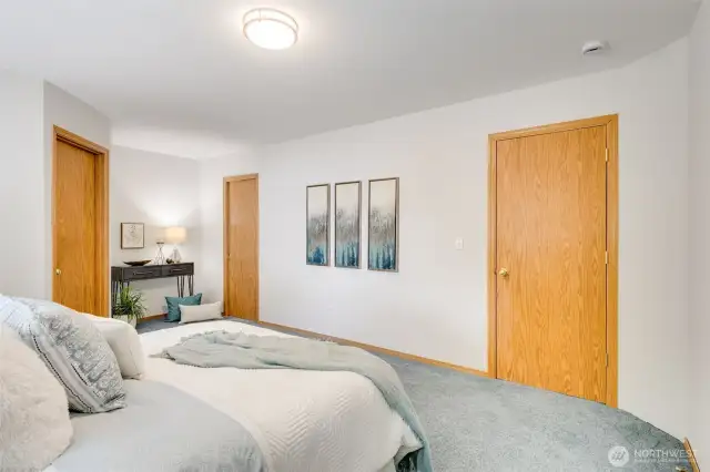 Another view showing the doors to the en-suite bathroom and primary closet.
