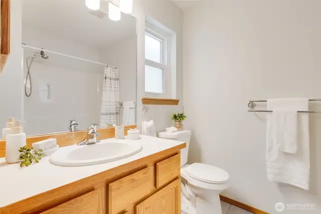 This primary holds a full bathroom with tub/shower combo.