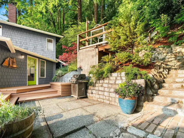 Stone steps and patio guide you to the front door.
