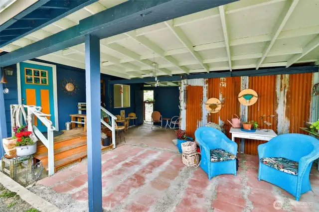 Carport and sitting area leading to front door