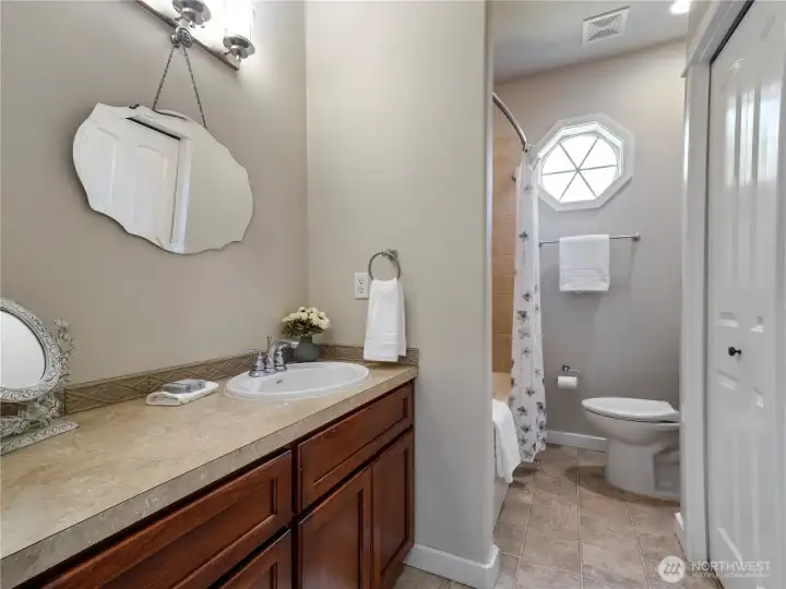 The vanity has an extended counter, bath/shower, linen closet, and a walk-in closet with built-in closet system.